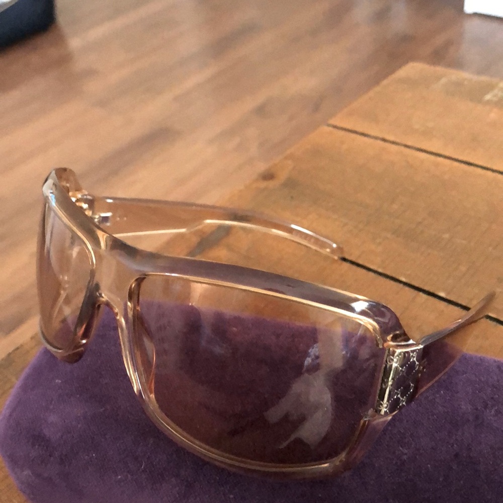 Gucci Sunglasses. They are a tan/brown with gold in the corner. They are cute!